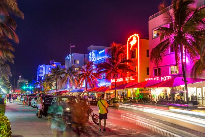 MIAMI, USA - AUG 19, 2014: peope visit Ocean drive buildings in Art deco style in Miami, USA. Art Deco district architecture is one of the main tourist attractions in Miami.