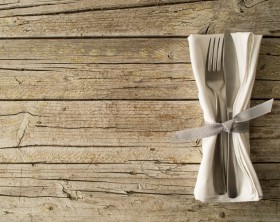Cutlery kitchenware on old wooden boards background food concept