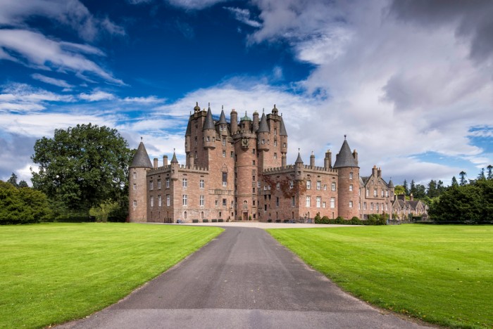 Glamis, United Kingdom - August 17,2014: View of Glamis Castle in Scotland, United Kingdom. Glamis Castle is situated beside the village of Glamis in Angus. It is the home of the Countess of Strathmore and Kinghorne, and is open to public.