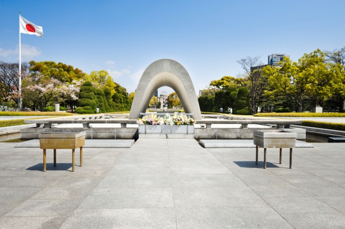 Hiroshima Peace Memorial and japanese flag in spring.