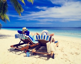 happy couple relax on a tropical sand beach