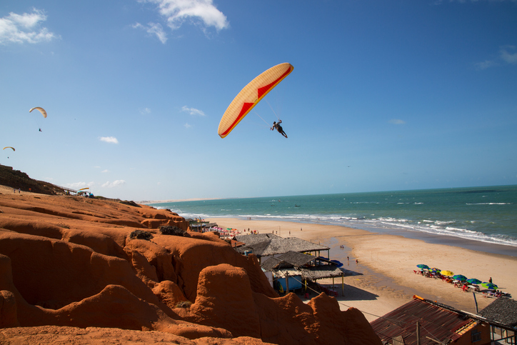 Canoa Quebrada, Ceará, Brazil - October 30, 2015: People paragliding at the Rocky Cliffs of Canoa Quebrada, Ceará, Brazil