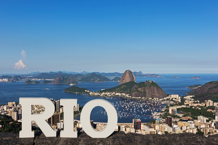 Day view of Sugar Loaf mountain and Botafogo Beach with the word RIO in the front, Rio de Janeiro, Brazil.