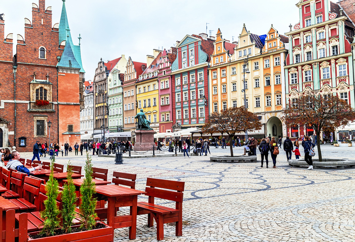 Wroclaw, Poland - October 17, 2015: People walking and resting on the famous, old market square in Wroclaw, Poland. Wroclaw is the historical capital of Silesia. Travel, vacation, arhitectura concept.