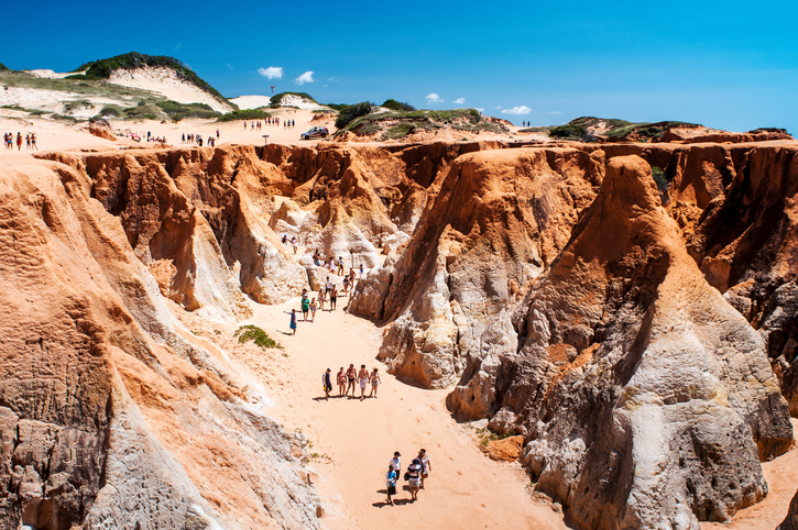 Morro Branco, Ceara State, Brazil - July 27, 2013: Tourists on the rocky beach, near Fortaleza city, in the north-east of Brazil