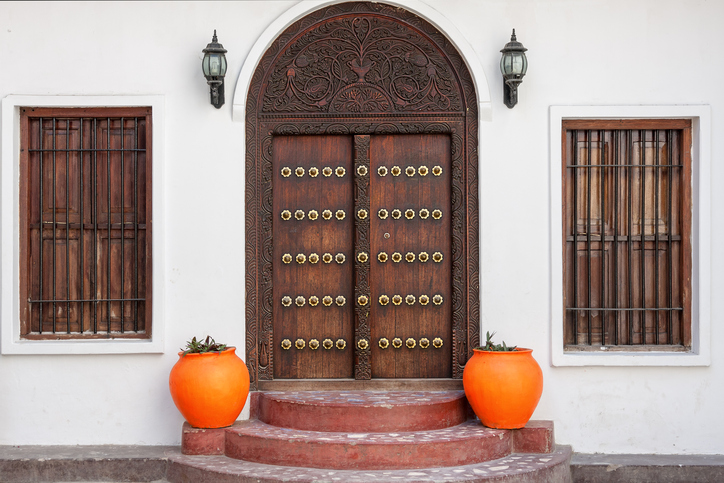 traditional zanzibar wooden door and doorway ornately carved and decorated with pots