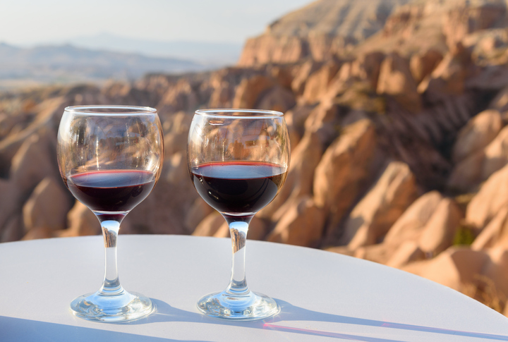 Red Wine glasses on Red valley background in Cappadocia. Nevsehir Province. Turkey