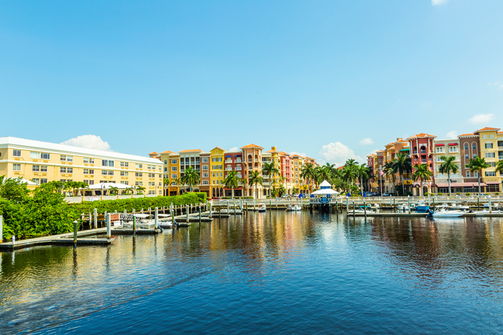 Colorful Spanish influenced buildings overlooking the water in tropical Naples Florida .
