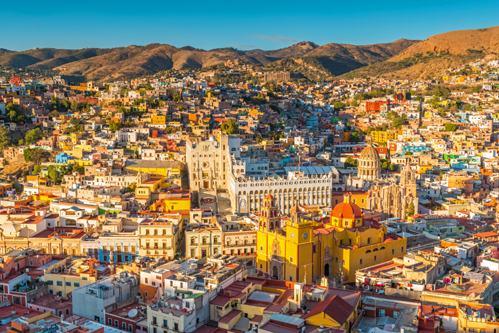 The last sun rays of the day shining on the skyline of Guanajuato city at sunset, Mexico.