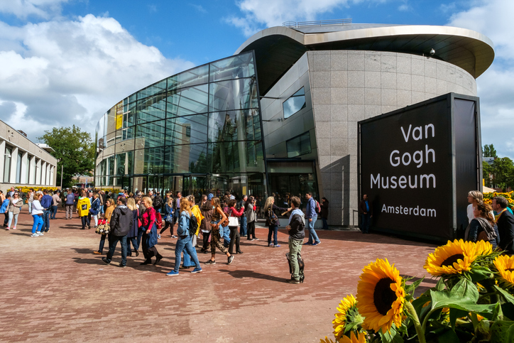 Amsterdam, the Netherlands, September 5, 2015: people in front of the new wing of the Van Gogh Museum with sunflowers