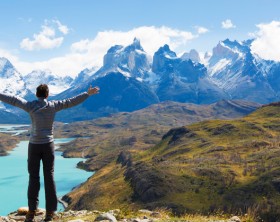 man at mirador condor enjoying hiking and view of cuernos del paine in torres del paine national park, patagonia, chile