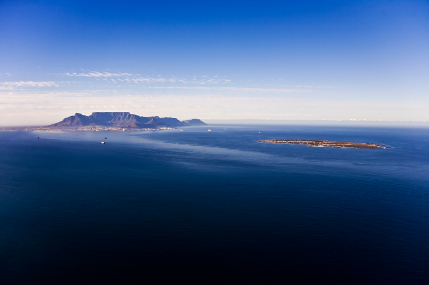 Aerial view of Robben Island with Table Mountain in the distance, Cape Town; South Africa. Former South African President, Nelson Mandela, was held here as a political prisoner for 27 years.