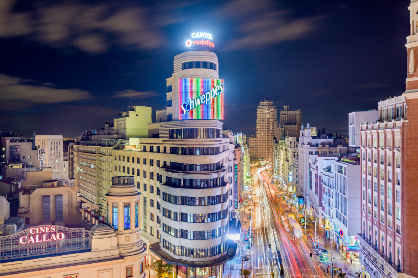 MADRID, SPAIN - OCTOBER 15, 2014: Gran Via at the Iconic Schweppes sign. The street is the main shopping district of Madrid.
