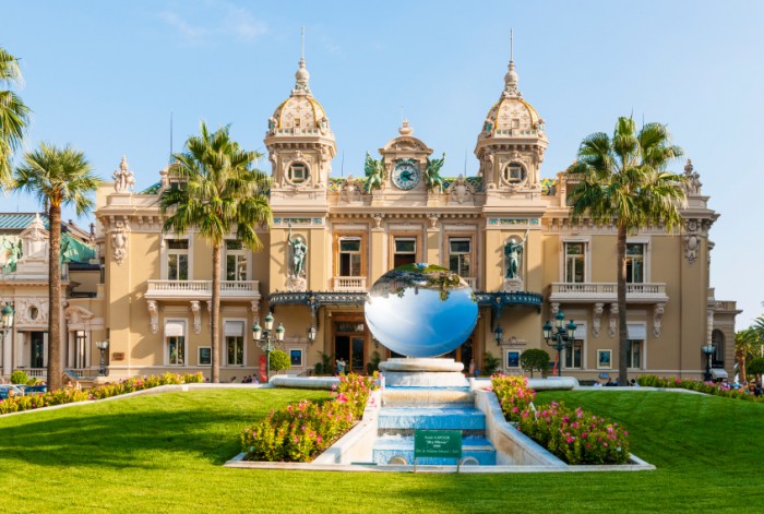 MONTE CARLO, MONACO - OCTOBER 3, 2014: Facade of Monte Carlo Casino in Monaco with Sky Mirror sculpture by Anish Kapoor in front