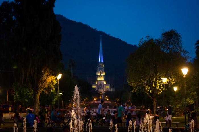 Petrópolis, Brazil- January 17, 2015: Metropolitan Cathedral  of Petropolis, Rio de Janeiro, Brazil. View from the Square of Freedom, where there is a fountain, and several people relaxing and having fun in an early dusk. The cathedral began to be built in 1884 in neo-Gothic style, and its patron is St. Peter of Alcantara.