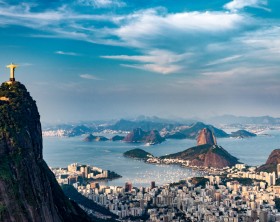 Aerial view of Rio De Janeiro. Corcovado mountain with statue of Christ the Redeemer, urban areas of Botafogo, Flamengo and Centro, Sugarloaf mountain.