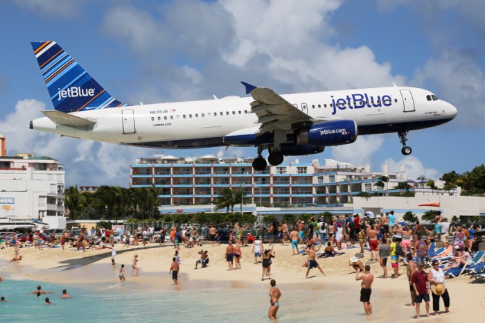 St. Martin, Netherlands Antilles - February 8, 2014: A jetBlue Airbus A320 with the registration N639JB approaching St. Martin Airport (SXM). St. Martin is rated one of the most dangerous airports in the world. JetBlue is an American airline, headquartered in New York City.