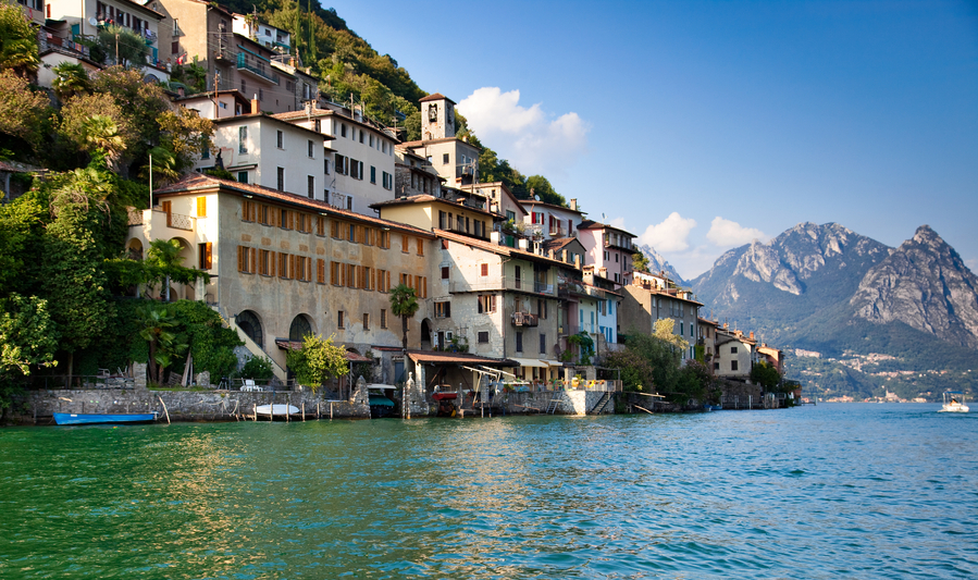 Lugano lake in Switzerland. View on shore with buildings.