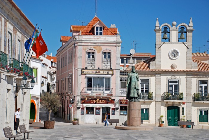 Cascais, Portugal - May 01, 2009: Beautiful buildings and statue of Don Pedro in Cascais on Lisbon's Sunshine Coast Cascais bay, Portugal. Cascais is popular vacation spot for Portuguese and foreign tourists.