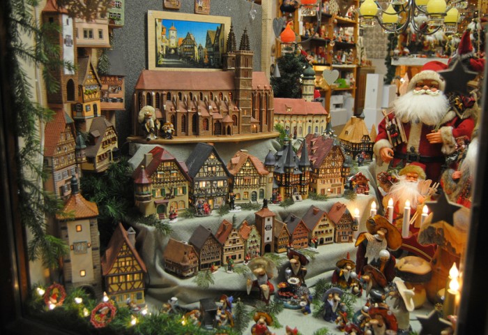 Rothenburg ob der Tauber, Germany – December 18, 2013. Shop window in Rothenburg ob der Tauber during Christmas, with santa clauses, historic candle houses, toys and candles.