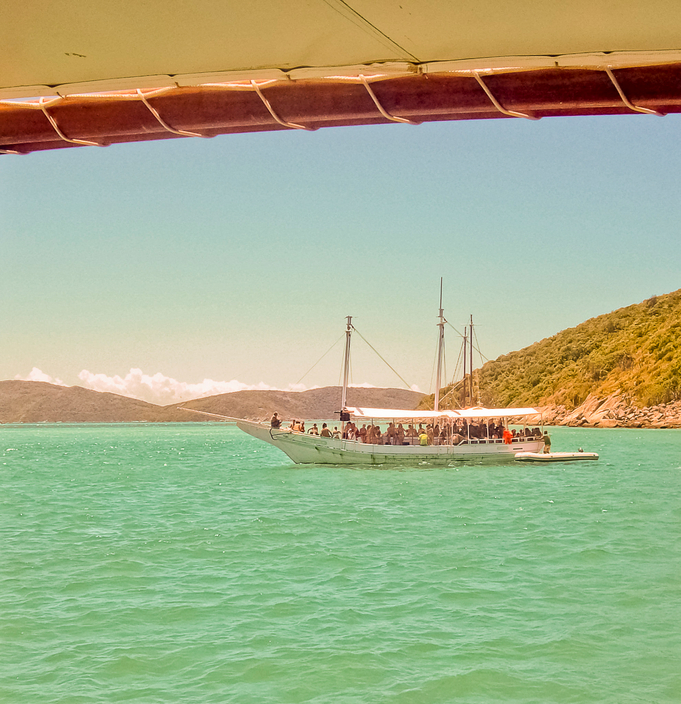 Small passenger boat in a beach of Buzios, Brasil, taken from another boat.
