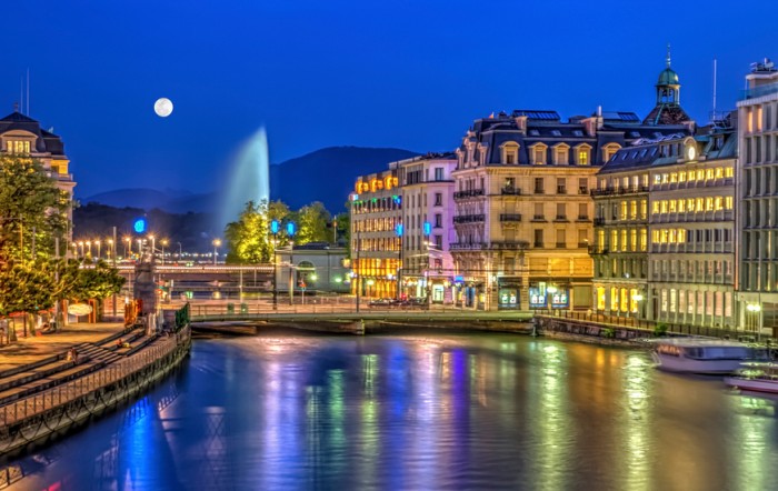 Urban view with famous fountain by night with full moon, Geneva, Switzerland, HDR