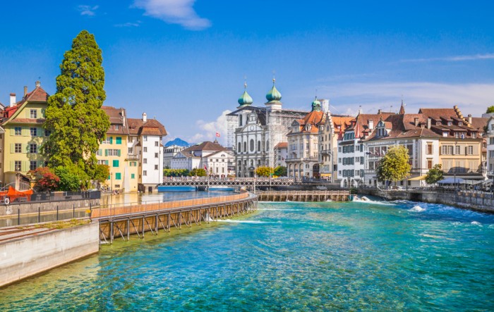 Beautiful view of the the historic city center of Lucerne with famous baroque Jesuit Church St Franz Xaver on a sunny day with blue sky and clouds in summer, Canton of Lucerne, Switzerland.