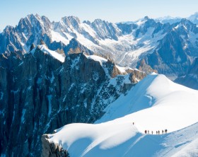 Mont Blanc mountaneers walking on snowy ridge. The mountain is the highest in the alps and the European Union.