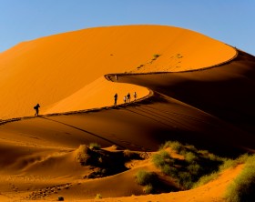 Tourists climbing Sossusvlei dune, Naukluft National Park, Namibia