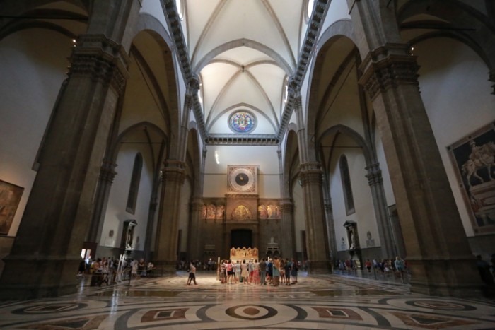 Tourists viewing artwork in the main hall of The Acaddemia in Florence, Italy