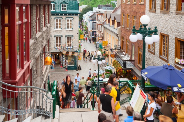 "Quebec City, Canada - July 28, 2006:  People walking past restaurants and store facades in the Petit Champlain neighbourhood of Quebec City, the oldest commercial district of North America."