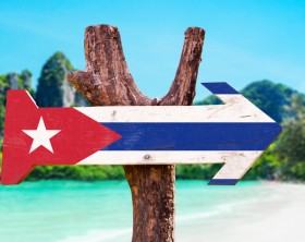 Cuba Flag wooden sign with beach background