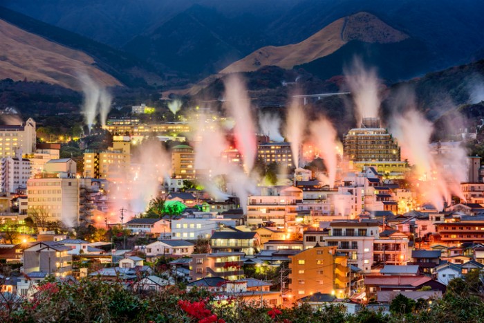 Beppu, Japan cityscape with hot spring bath houses with rising steam.