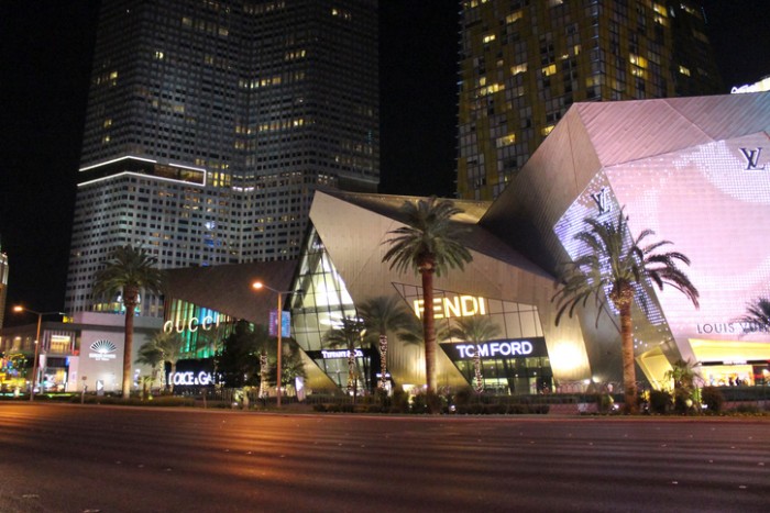 Las Vegas, NV, United States - October 22, 2014: View of the Gucci, Fendy, Tiffany & co, Fendi and Louis Vuitton Stores illuminated at night with Mandarin hotel on background. These Stores are some of the most famous on Las Vegas Strip.