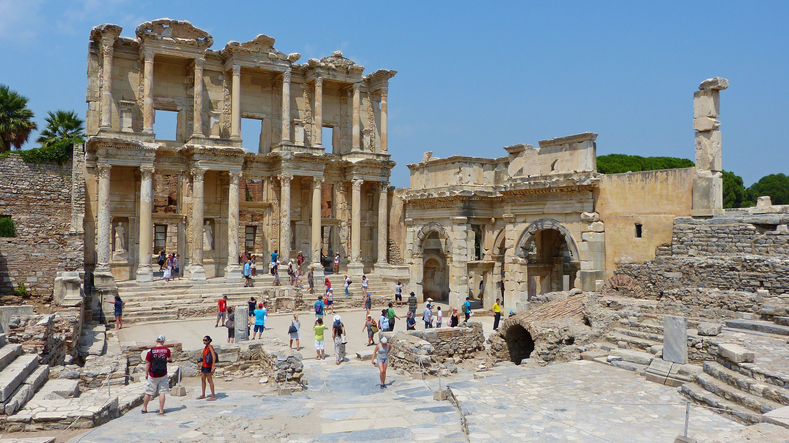 Ephesus, Turkey – August 11, 2013. Ruins of the Library of Celsus in Ephesus - the third largest library in the ancient world, with people.