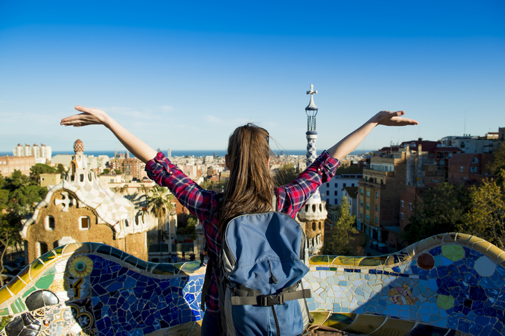 Rear view of young female tourist enjoying the view in Parc Guell in Barcelona, Spain.