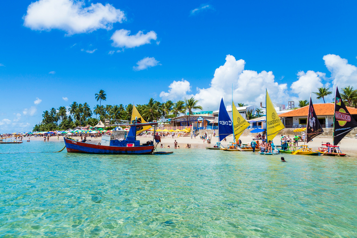 People enjoying a hot day on the Fishing boat (Jangada) in Porto de Galinhas, Pernambuco, Brazil