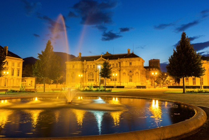 Grenoble, Rhône-Alpes, France - August 19, 2015: Place de Verdun with Grenoble-Library Museum in Grenoble in France. There is a fountain in the foreground and there are no people in the photo.