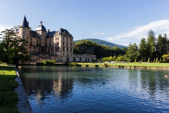 Vizille, Auvergne-Rhône-Alpes, France - August 14, 2015: Castle in Vizille in France during a sunny day. It is one of the most prestigious and important castles of the Dauphiné Region. The castle park has a total of 320 acres of space and was classified as a historic monument.
