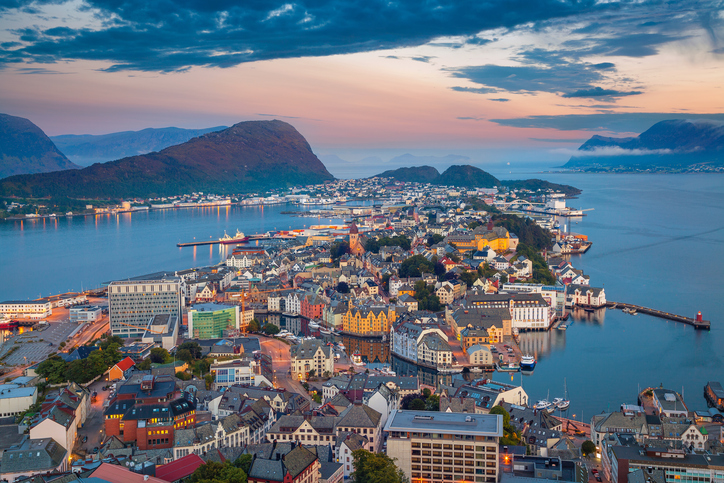 Cityscape image of Alesund, Norway at dawn.