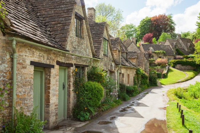 Old street with traditional cottages in  beautiful spring day , Bibury, England, UK.