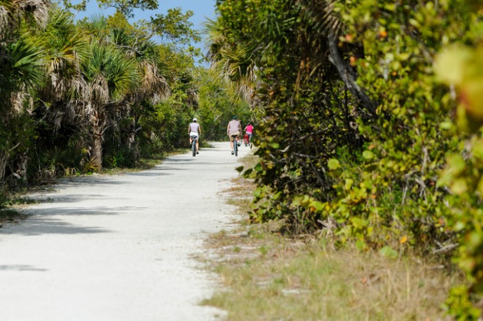 Sanibel Island, Florida, USA - February 25, 2011: Cyclists riding sandy trail through Ding Darling National Wildlife Refuge
