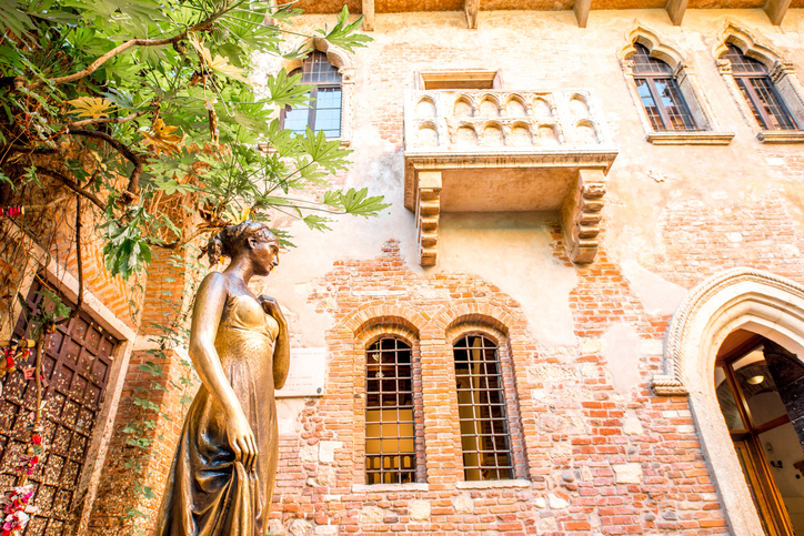 Verona, Italy - May 22, 2016: Juliet statue and balcony in Verona. Romeo and Juliet is a tragedy written by William Shakespeare. This place is the main tourist attraction in Verona.