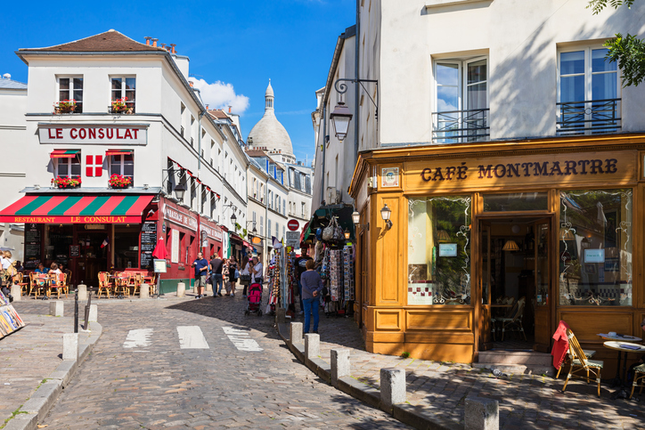 Paris, France - July 06, 2016: The charming quarter of Montmartre hill near basilica Sacre Coeur with traditional french cafes and art galleries. Montmartre is one of the most visited landmarks in Paris