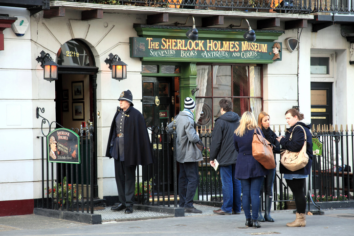 London, UK - January 6, 2012: Tourist and a Policeman actor outside the Sherlock Holmes Museum at 221B Baker Street, the home of the famous fictitious Victorian private detective