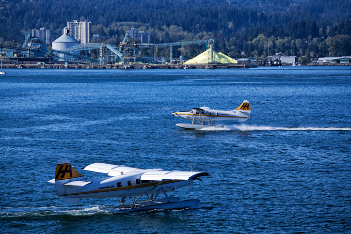 Vancouver, Canada - April 30, 2014: Two sea planes at Vancouver harbour, sulfur terminal in the background.