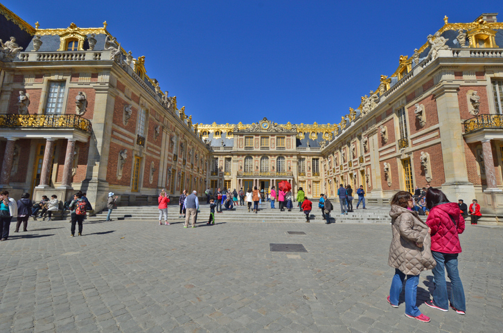Versailles, France - April 19, 2015: Tourists visiting Versailles Palace, UNESCO list of World Heritage Sites, in the city of Versailles, France.