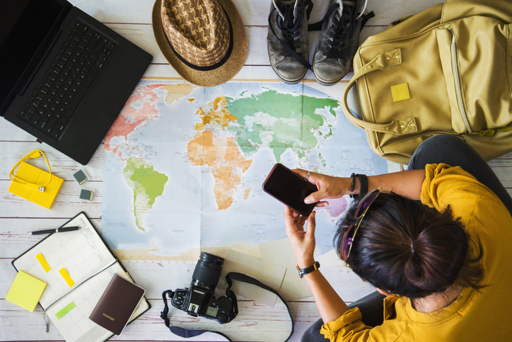 Vacation travel planning concept with map. Overhead view of equipment for travelers. Travel concept background, young Asian woman. Travel holiday, summer.