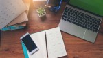 Diary Calendar and agenda for Planner to plan timetable, appointment, organization at office. Desktop Calender 2021, smartphone, clock, book, and cup of coffee place on desk.Calendar Background Concept.