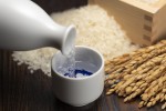 Cold sake with rice and ear of rice on the table